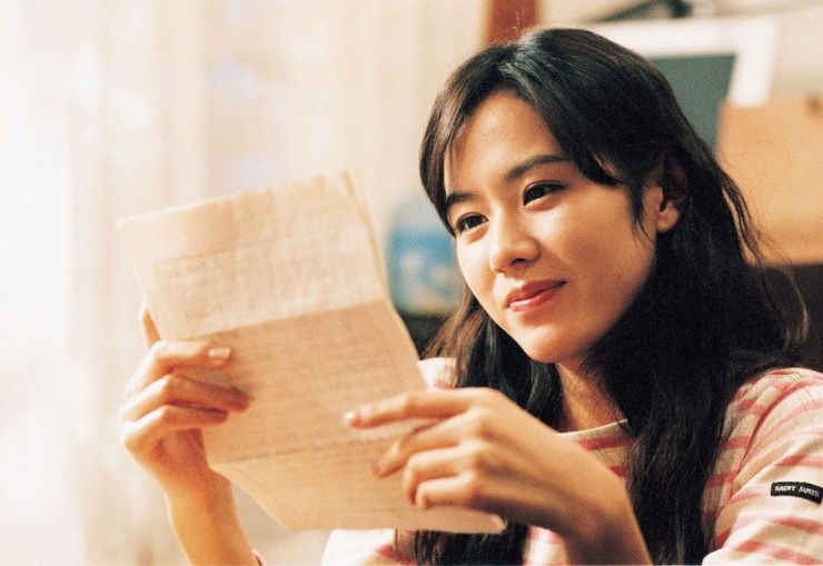 Girl reading a letter.